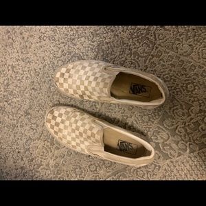 Well worn white checkered slip on vans